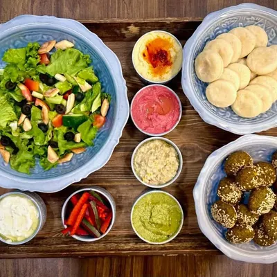 This is my most popular Mezze Platter, and you can see why! It's a full spread with classic hummus, beetroot hummus, pesto hummus, baba ghanoush, falafel, labneh, fattoush salad, pickles, and mini pita breads.