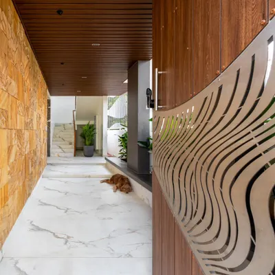 The entrance of the Avani Residence sets a welcoming tone with its spacious, well-lit design. We used a neutral color palette, calming textures like Jaisalmer stone, and a custom metal gate to merge heritage with modernity.