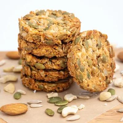 My 7-Seeds Nuts Cookies are a customer favorite for a reason. This shot shows a stack of these healthy cookies, which are loaded with pumpkin seeds, sunflower seeds, almonds, and cashews.