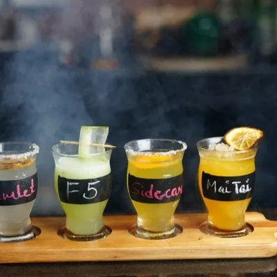 A flight of our classic cocktails: Gimlet, F5, Sidecar, and Mai Tai. It's the perfect way to sample our mixology skills and find your new favorite drink.