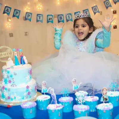 The birthday girl's priceless reaction at her Frozen-themed party. I love capturing the excitement around the cake and decorations.