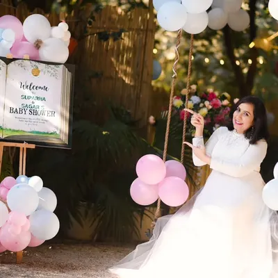 We can create a full baby shower theme for your photoshoot. This setup includes a welcome sign and festive balloons, making it a perfect way to celebrate and announce your joy.