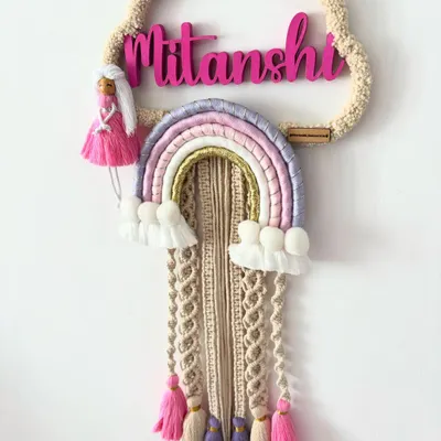 A beautiful and detailed name hanging I made for a customer's daughter, Mitanshi. I combined a rainbow, tassels, and a little doll to create a piece that is as unique as she is.