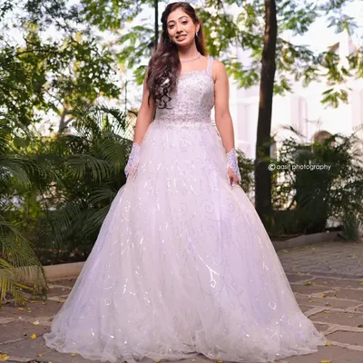 Feel like royalty in this stunning white ball gown. The full, sparkling skirt and detailed bodice create a breathtaking silhouette, perfect for a grand entrance or a fairytale photoshoot.