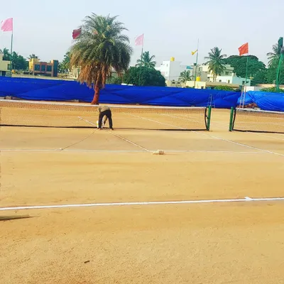 Constant upkeep is key to a great court. Here you can see our staff performing daily maintenance, ensuring the clay is perfectly leveled and ready for play. This commitment to quality is what sets our courts apart.