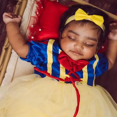 Our little Snow White, looking absolutely perfect. We provide the full costume and set, including the miniature bed and woodland props, for a complete fairytale experience.