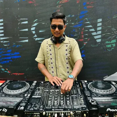 At the console during a pre-wedding 'Coffee Rave' themed event. I adapt my style and setup to match unique party themes, complete with custom visuals on the LED screen.