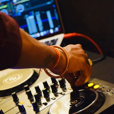 Every adjustment on the mixer is about shaping the sound and guiding the energy of the room. This close-up shows my hands-on approach to mixing live, ensuring every transition is smooth.