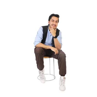 A professional portfolio headshot for a male model, seated and smiling. These clean, well-lit shots are essential for casting calls and profiles.
