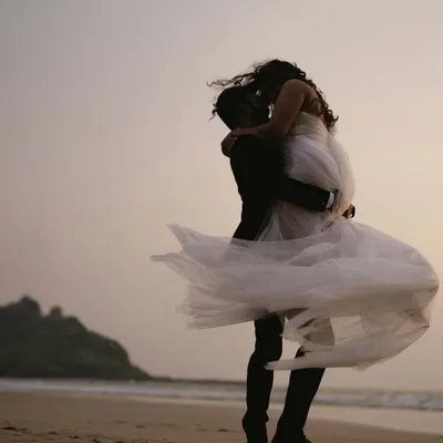 This is the shot that feels like a fairytale ending. Lifting her against the vast Goan sky, with her dress catching the wind, we created a moment of pure cinematic romance.