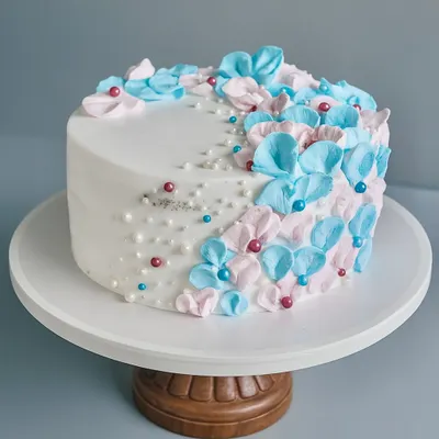 Welcoming a little bloom with a cake as delicate as the moment. This is a classic Black Forest cake wrapped in soft blue and pink florals for a very special baby shower.