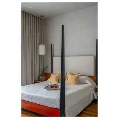 This four-poster bed was custom designed with a lacquered wood frame inspired by Channapatna crafts. The clean lines and bold color make it a modern heirloom piece that tells a personal story.