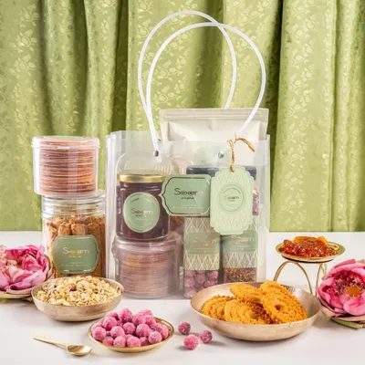 A wedding gift should feel like a pause, a quiet smile before the celebration begins. This hamper is filled with golden laddoos, crunchy chaklis, and wholesome snacks that carry stories and warmth.