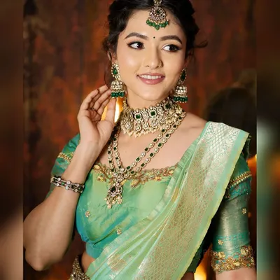 A full-length portrait of actress Samiksha styled in a stunning pastel green and gold lehenga. I managed the complete look, including the traditional jewelry and hair styling.