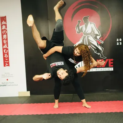 A powerful throw being executed during a grappling session. This dynamic shot showcases the high level of skill and control taught in our Brazilian Jiu-Jitsu and MMA classes.