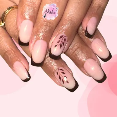 Nude and black is always a power combo. This elegant design features a modern French tip with delicate, hand-painted leaves on the accent nails.