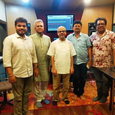 A happy moment in the studio after recording new original songs. This photo captures the team of composers, arrangers, and musicians involved in bringing a new piece of music to life.