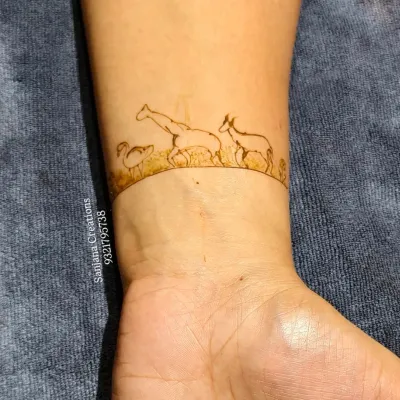 A close-up of a unique baby shower wristband design. This one features a giraffe, a duck, and a deer, showcasing how we can create personalized and themed art.