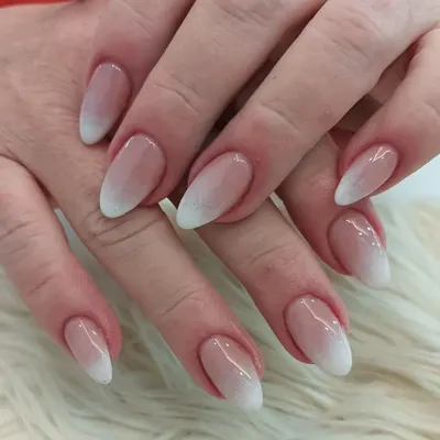 The perfect baby boomer ombré on elegant almond-shaped nails. This design features a seamless transition from a natural pink base to a soft white tip for a timeless and sophisticated look.