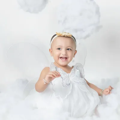A little fairy with the sweetest laugh. My angel wing and cloud setup creates a dreamy, heavenly scene for your little one.