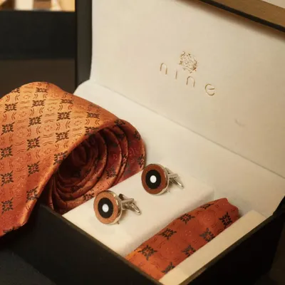 This classic gift set features a patterned silk tie, matching pocket square, and elegant cufflinks. It's a versatile and thoughtful gift for any formal occasion.