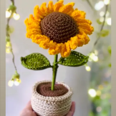 Brighten up any desk or room with this adorable handcrafted crochet sunflower in a pot. It's a little piece of sunshine that will never wilt, perfect for bringing joy to a workspace.