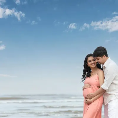 An intimate embrace on the beach, with the vast ocean behind them. This is a beautiful portrait of two people ready to start a new chapter together.