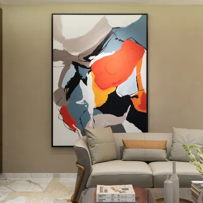The power of abstract art. This large, dynamic painting with its bold strokes of orange, blue, and black becomes the immediate focal point of the living room, adding energy and movement to the neutral space.
