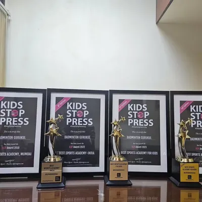 A display of our trophies and framed certificates from the Kids Stop Press Awards, where we were named Best Sports Academy in India.