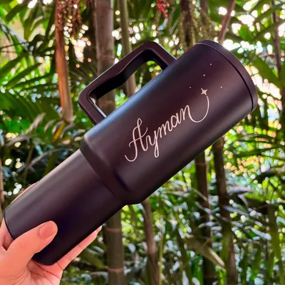 This sleek black tumbler, engraved with the name 'Ayman' and a small star, is a great example of a personalized birthday gift. The silver engraving contrasts beautifully against the matte black finish.