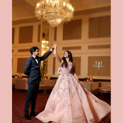 A fairytale dance under a magnificent crystal chandelier. The bride's flowing gown and the grand ballroom setting create a scene straight out of a romance novel. This is elegance personified.