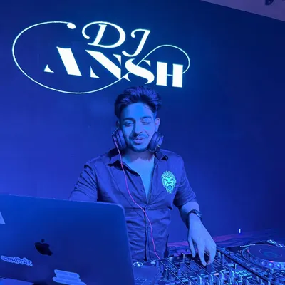 In my element behind the Pioneer DJ console, with my custom logo glowing in the background. This is my office, and I'm ready for the night.