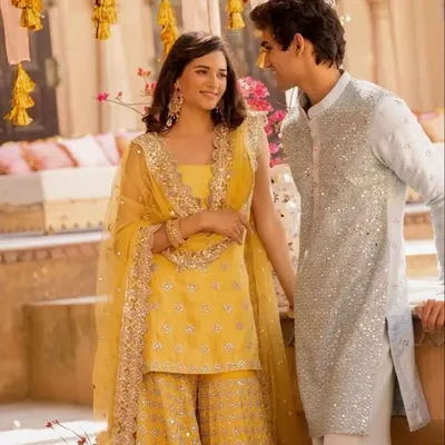 The elegance of a matching yellow sharara and sequined kurta is undeniable. If you love this festive look, I can create a similar custom-designed set for your Haldi or Mehendi.