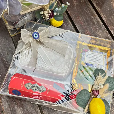An overview of a Roka trousseau designed with a Moroccan and Evil Eye theme. The transparent acrylic trays are filled with curated gifts and embellished with evil eye charms, lemon motifs, and dried florals for a cohesive and stylish look.