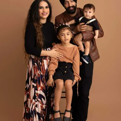 A beautiful family portrait showcasing coordinated earth-toned outfits. My studio provides a perfect neutral backdrop to make your family's connection the star of the show.