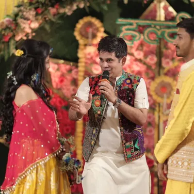 A candid shot from a Mehendi ceremony, sharing a laugh with the bride and groom. These are the real, unscripted moments that make a wedding special.
