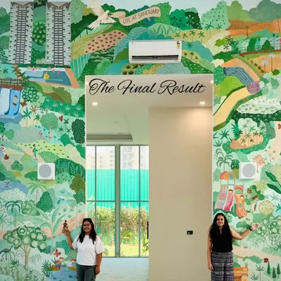 The final result of a 400 sq ft mural for a real estate sales center in Greater Noida. The artwork visualizes the theme of sustainable community living, showcasing the amenities and green spaces offered in the project.