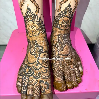 A full view of this intricate floral foot mehendi, with the design covering the top of the feet and toes.