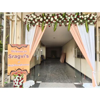 A welcoming entrance for Sragvi's Half Saree Ceremony. We created an elegant arch with drapes and a floral valance, complete with a personalized welcome sign for the guests.