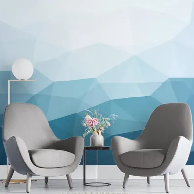 Our Blue Geometric Mural Wallpaper adds a cool and contemporary touch to this living room. The gradient of blues creates a calming and modern atmosphere.
