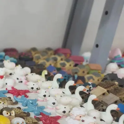 A collection of our miniature animal and house figurines. We have everything from tiny swans and sheep to little cottages, perfect for creating a fairy garden scene.