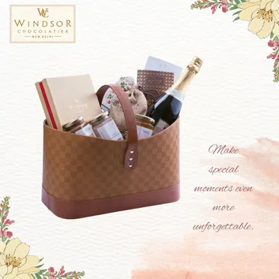 Make any moment unforgettable with a custom luxury hamper. This example features a bottle of sparkling wine alongside our artisanal chocolate boxes and gourmet spreads, all packed in a stylish checkered basket.