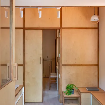 The interior of the 'Urban Sanctuary' clinic in Pune uses warm plywood panels and built-in furniture to create a calming, non-clinical atmosphere.