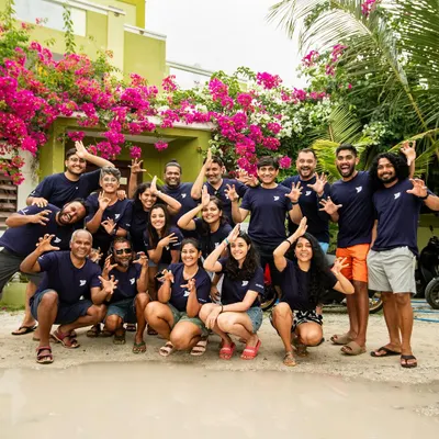 The 'shark sign' is mandatory after a successful tiger shark trip in Fuvamulah, Maldives. This group was an absolute riot, and their energy was infectious.