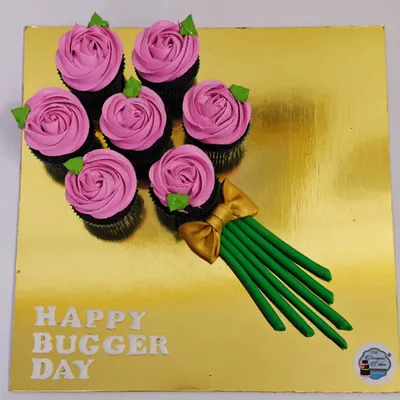 Why give flowers when you can give a cupcake bouquet? This creative arrangement features six chocolate cupcakes piped with pink frosting to look like roses, all presented on a golden board.
