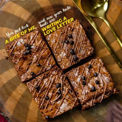 A love letter in brownie form. This overhead shot shows our classic chocolate chip brownies, perfectly cut and drizzled with more chocolate, ready to be devoured.