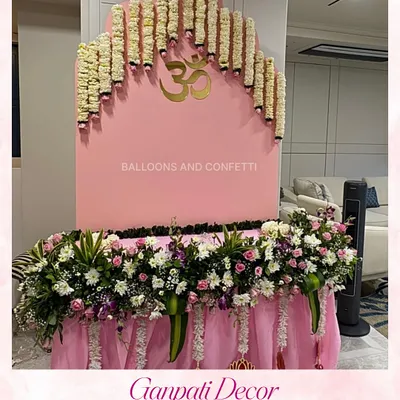 A close-up of a Ganpati decor setup, showing the beautiful arch of fresh tuberose garlands against a soft pink backdrop. This design focuses on simplicity and elegance to create a divine atmosphere.