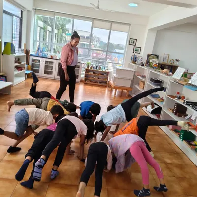 A dance and movement session in full swing. Children explore different ways their bodies can move, developing balance, coordination, and creative expression.