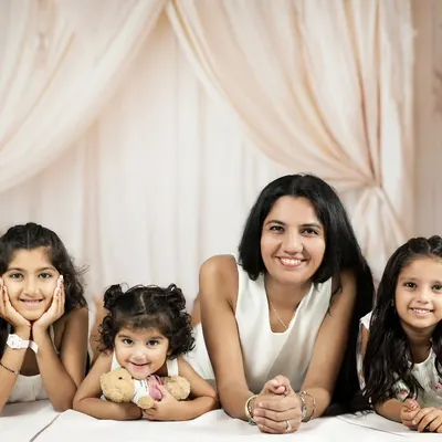 A mother and her three daughters, a beautiful gang of girls. This portrait, taken in our studio with a soft, neutral boho setup, captures the strong and loving bond they share.