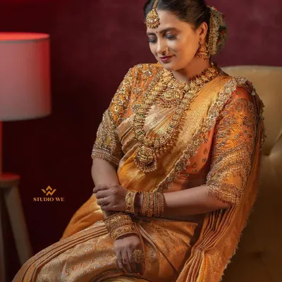 A stunning bridal portrait showcasing the bride's elegance and poise. The warm lighting and classic pose create a timeless and sophisticated image.